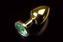 Маленькая золотистая анальная пробка с круглым кончиком и изумрудным кристаллом - 7 см - Пикантные штучки